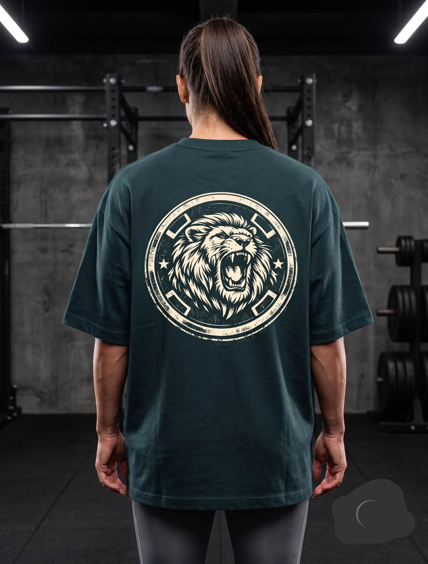 Woman wearing dark green lion graphic oversized gym t-shirt in gym