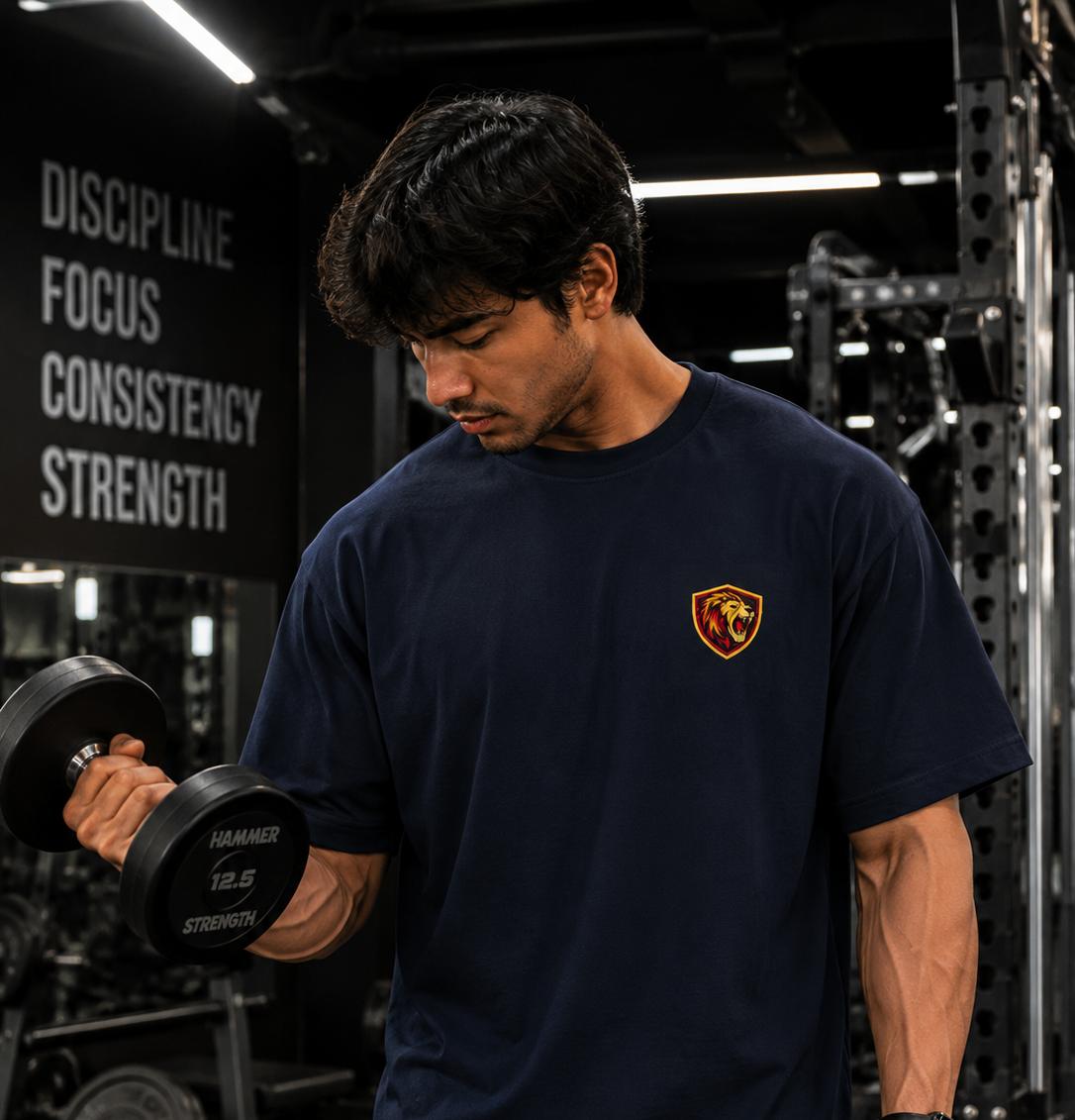 Navy oversized gym t-shirt with lion logo during dumbbell workout