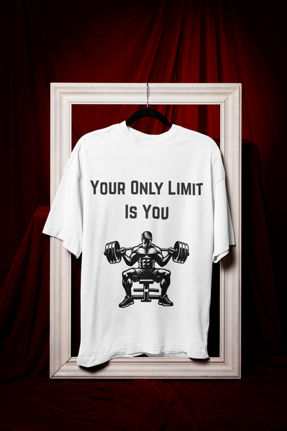 Man wearing an oversized beige t-shirt with "Your Only Limit Is You" quote and bodybuilding graphic.