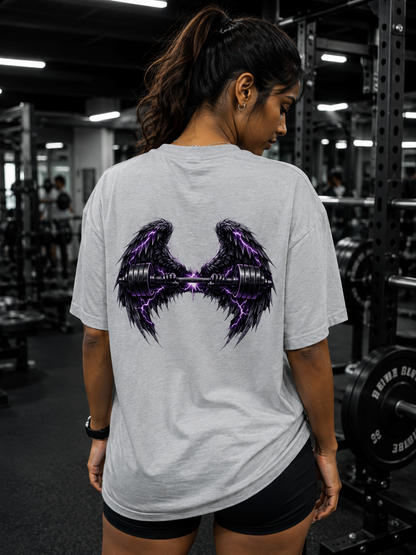 Woman wearing grey oversized gym t-shirt with purple wing and dumbbell back print