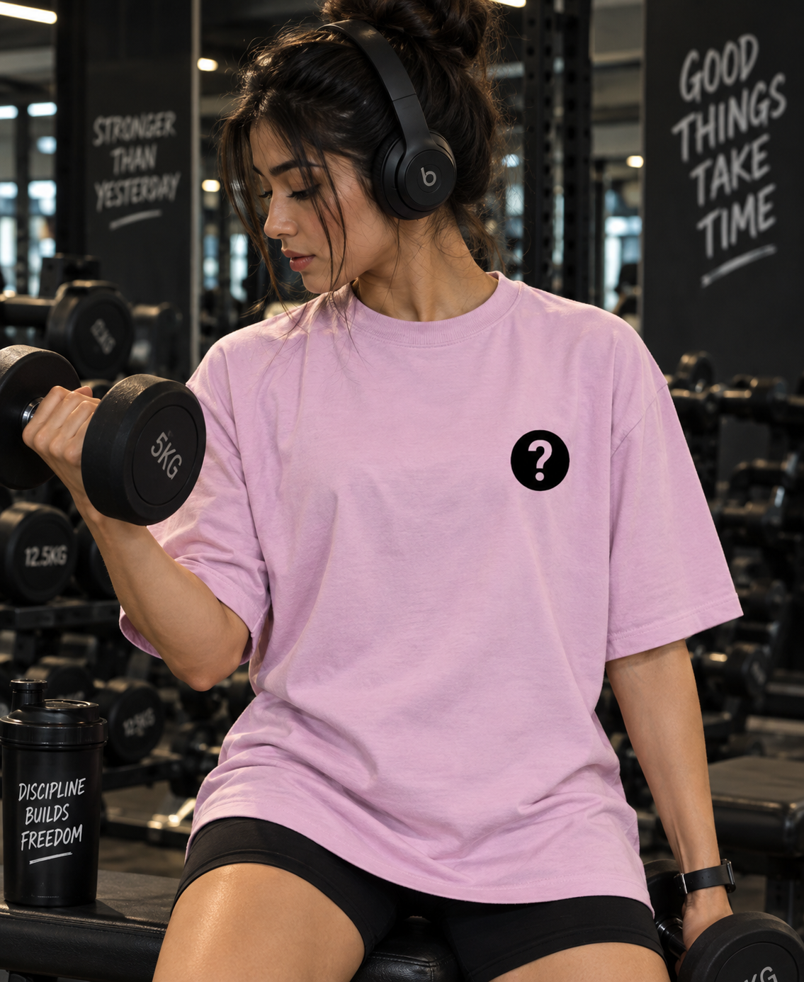 Female model training in pink But Did You Die oversized gym t-shirt
