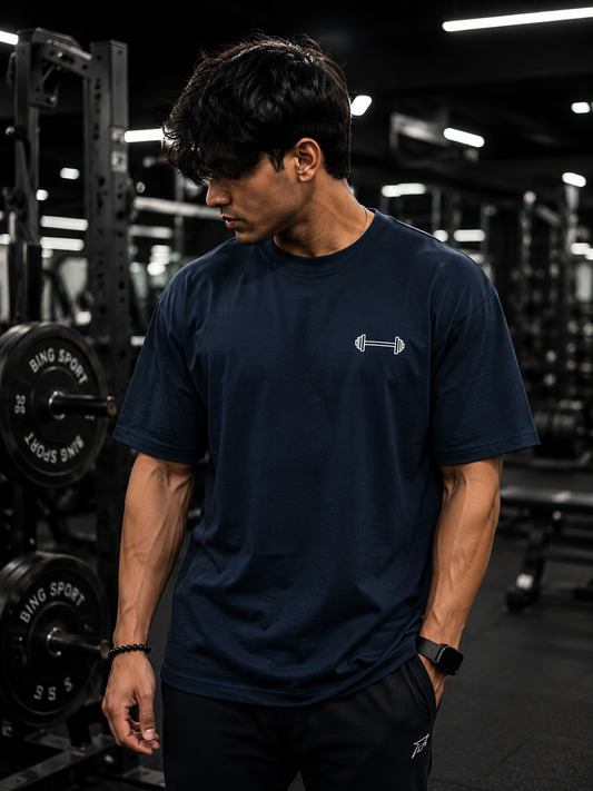 Man wearing navy blue UNIMCOLL Mind Set oversized gym T-shirt with dumbbell front graphic