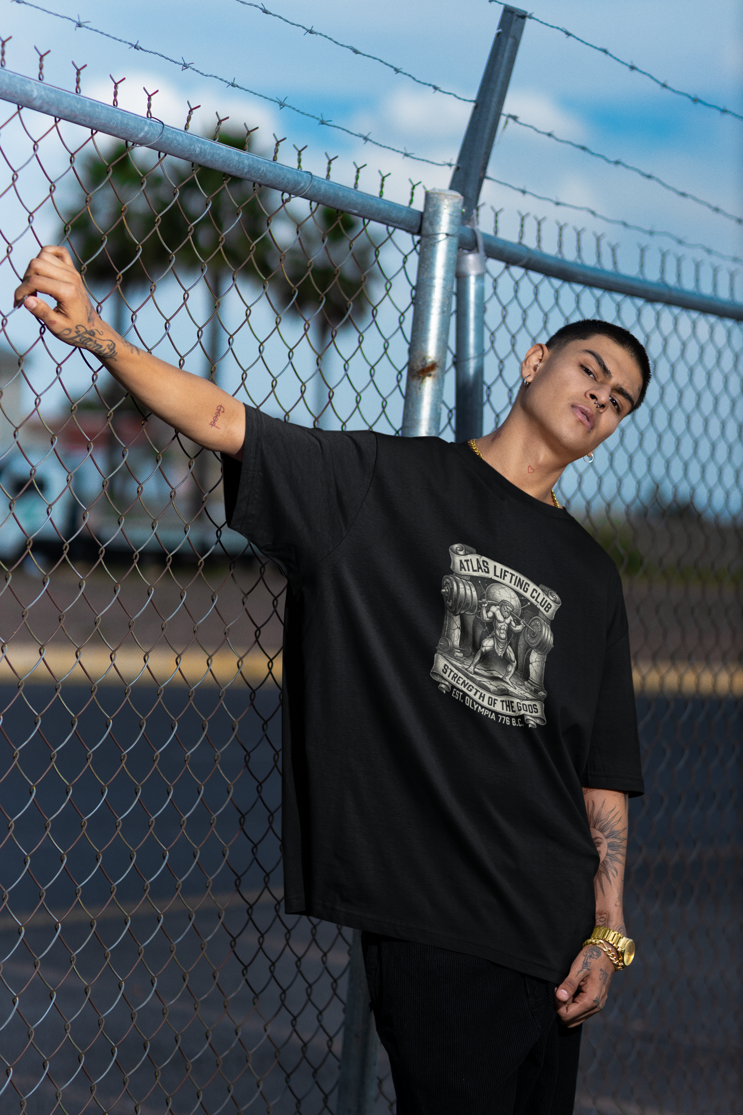 Model wearing Black Atlas Lifting Club oversized pump cover t-shirt by UniMcoll.