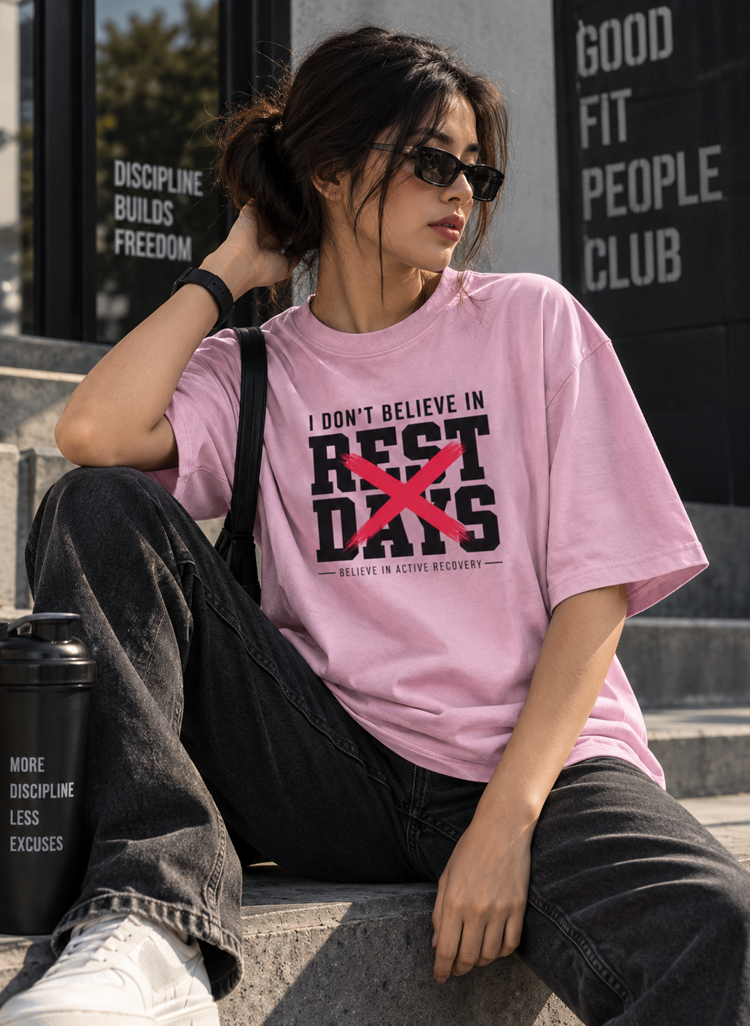 Female model wearing pink Rest Days oversized streetwear t shirt